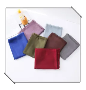Detailed view of multiple solid color slub long scarves and shawls in various vibrant hues.