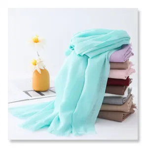 Detailed view of lightweight solid color bamboo fiber scarf stack with delicate fringe edges.