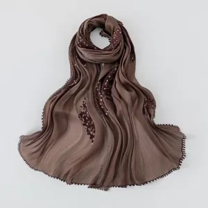 Detailed view of brown island silk hijab with exquisite embroidery and sparkling sequin details.