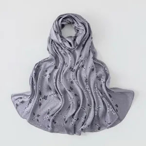 Detailed view of grey imitation silk scarf with delicate black and white floral prints.