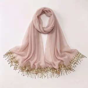 Elegant dusty pink chiffon hijab with gold sequin fringe embroidery, perfect detail shot.