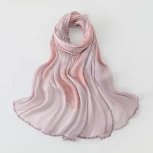 Detailed view of island silk embroidered sequin scarf showing delicate craftsmanship and texture.