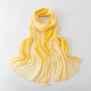 Yellow island silk embroidered long scarf detail close-up, elegant sequin shimmer texture.