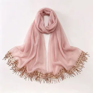 Elegant light pink chiffon hijab scarf featuring sparkling sequin and tassel trim details.