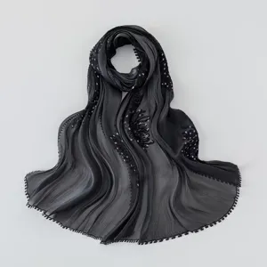 Detailed shot of black pleated island silk hijab, featuring delicate embroidery details.