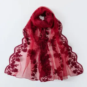 Detail view of the elegant wine red lace embroidered scarf, featuring delicate floral patterns.