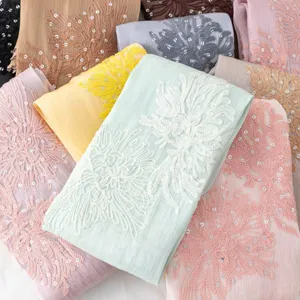 Detail shot of exquisite island silk embroidered sequin long scarf shawl fabric close up.