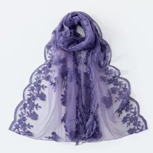 Close-up view of the delicate floral embroidery and sheer lace texture on this purple scarf.