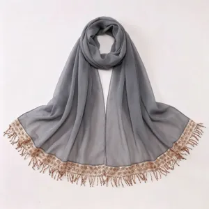 Detailed view of grey chiffon hijab scarf with sparkling sequin tassel trim border close up