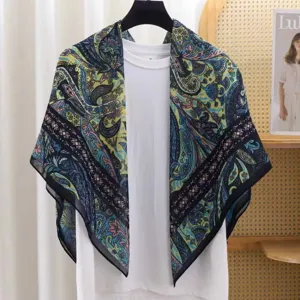 Detail view of the vintage paisley print square scarf, elegant blue and green tones.