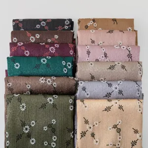 Detailed view of women's silk-feel printed floral long scarves showing various color options.