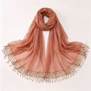 Elegant chiffon long hijab scarf featuring sparkling sequin embroidery and delicate tassels.