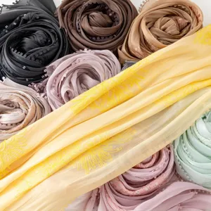 Detailed view of women's sequined embroidered sea island silk long scarf in vibrant colors.