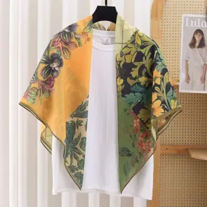 Detailed view of a French vintage floral print square scarf draped on display, elegant silk-cotton.