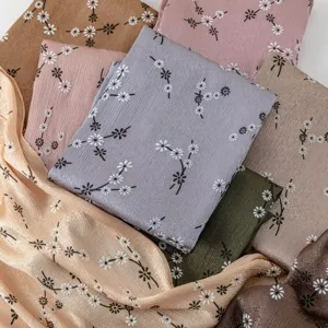 Detailed close-up of printed imitation silk floral long scarves showcasing various elegant colors.