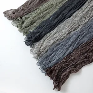 Detail view of crinkled striped sheer scarf fabric texture and multiple color options.