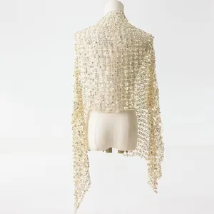 Detail view of the elegant gold sequin mesh shawl, sparkling evening party accessory cape.