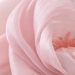 Close-up detail of pink island silk embroidered long scarf shawl with delicate sequins.