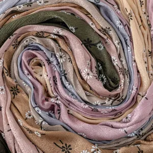 Close-up detail of soft imitation silk long scarf with cute floral print in vibrant colors.