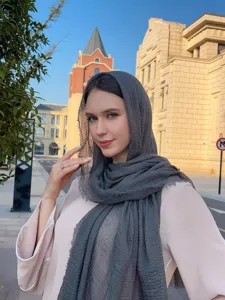 Close-up detail shot of the grey crinkled bubble hijab scarf worn outdoors gracefully.