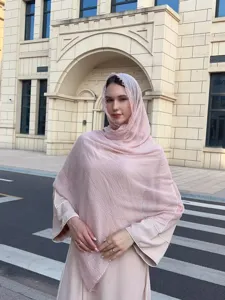 Details of the solid color bubble scarf and lightweight shawl showing soft texture and elegant drape.