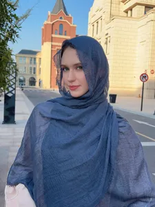 Detailed view of the solid blue crinkle hijab and travel scarf, showcasing lightweight fabric texture.