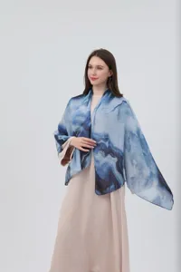 Detailed view of women watercolor gradient silk scarf shawl, elegant blue draped design.