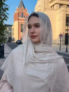 Detailed view of lightweight bubble gauze scarf, breathable shawl for outdoor travel.