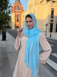 Detailed shot of a lightweight solid color bubble scarf, offering soft texture and elegant drape.