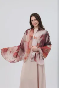 Detailed shot showing the soft satin fabric texture and watercolor gradient print of the shawl.