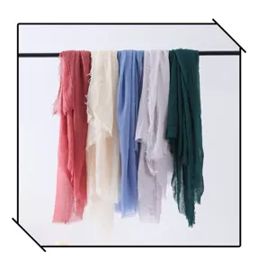 Multi-color bubble scarves hanging display, lightweight crinkle fabric, fashion accessory detail.