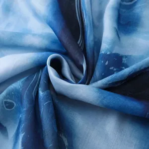 Blue watercolor gradient printed scarf fabric detail close-up showing soft texture design.