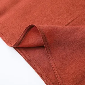 Gros plan sur le tissu de l'écharpe unie en lin pour femme, coutures et texture fines.