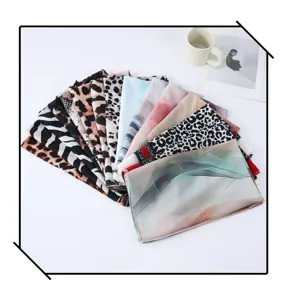 Detailed view of fashionable watercolor and leopard print satin polyester long scarves set.