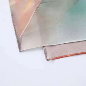 Detailed view of the watercolor abstract printed satin polyester fashion scarf edge.