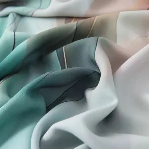 Satin polyester scarf fabric detail, watercolor tie-dye pattern, smooth texture and drape.