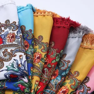 Detailed view of traditional ethnic style floral print scarf shawl with delicate fringe edge.