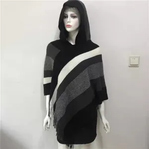 Women's hooded knitted poncho cape with diagonal stripes, sparkly yarn and tassels.