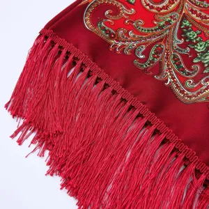 Detailed view of women's autumn winter ethnic style red fringe scarf shawl with paisley print.