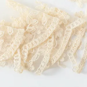 French vintage beige floral lace scarf detail, elegant embroidered sheer shawl fabric.