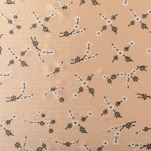 Detailed close-up of smooth satin fabric featuring elegant floral print pattern design.