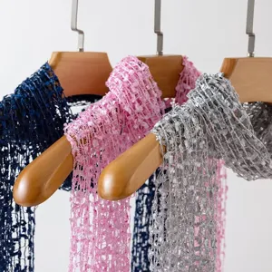 Detailed view of fashionable women sequin tassel hollow long scarf in versatile colors.