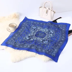 Detailed shot of a stylish vintage blue paisley print square scarf, ideal for chic neckwear.