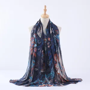 Detailed close-up view of the watercolor floral print dark blue scarf showing fabric texture.