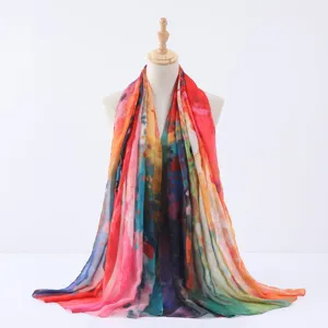 Close-up detail of a vibrant watercolor tie-dye women fashion scarf shawl drape.