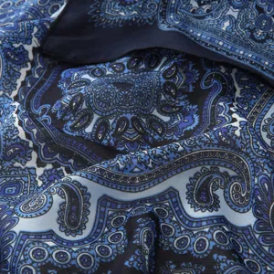 Detailed view of retro printed square scarf, elegant blue paisley neckerchief accessory.