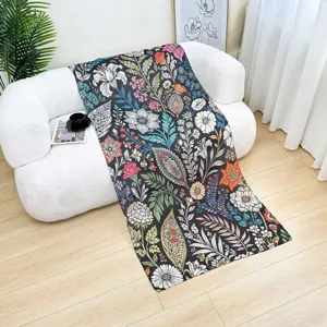 Detailed view of the colorful floral watercolor print textile draped on a modern white sofa.
