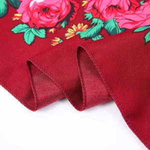 Detailed view of red floral vintage square scarf showing fine twill fabric texture and hems.