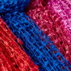 Detailed shot of colorful sequin tassel knitted scarf fabric, close up texture view.