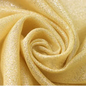 Close-up of shimmering metallic gold mesh fabric, soft texture, elegant scarf detail view.